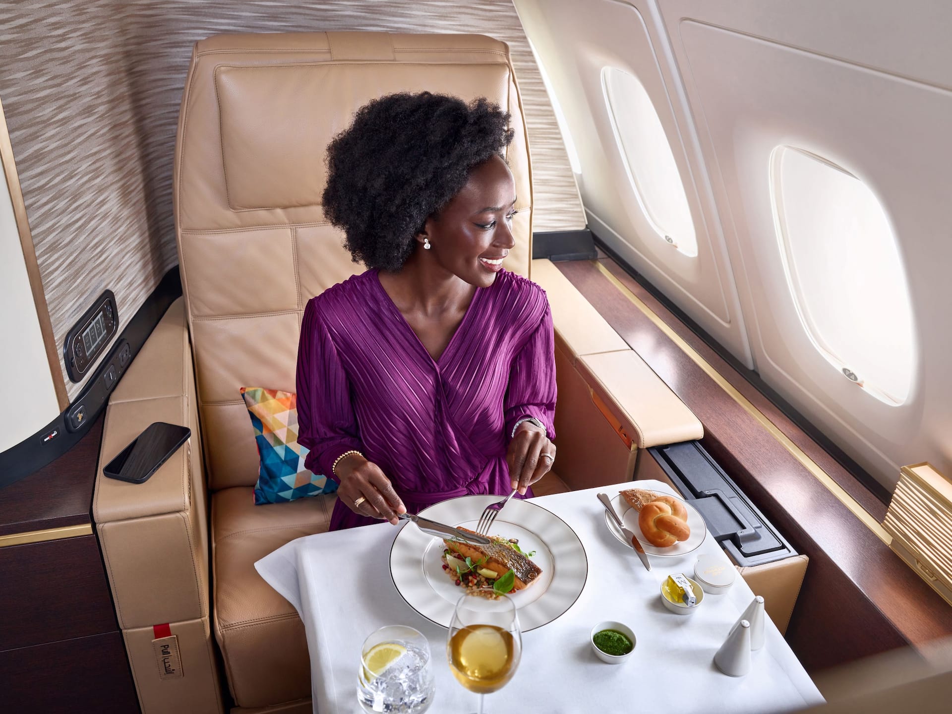 Passenger enjoying a meal in an Etihad premium cabin